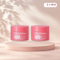 Pack of two Glad2Glow PDRN moisturizers on a pale pink studio pedestal