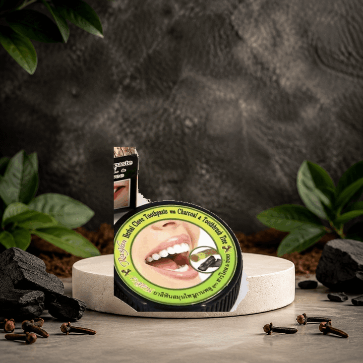 Authentic Rasyan Herbal Clove Toothpaste with Charcoal 25 g jar in a clove and charcoal setting