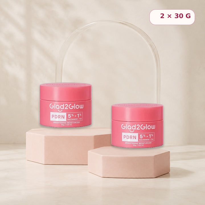 Two Glad2Glow PDRN moisturizers displayed on blush pink risers