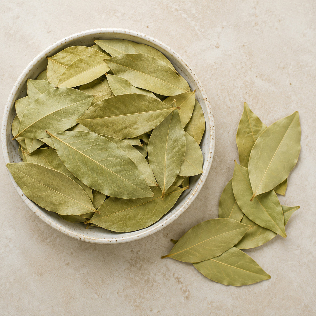 Whole dried bay leaves in a serving bowl