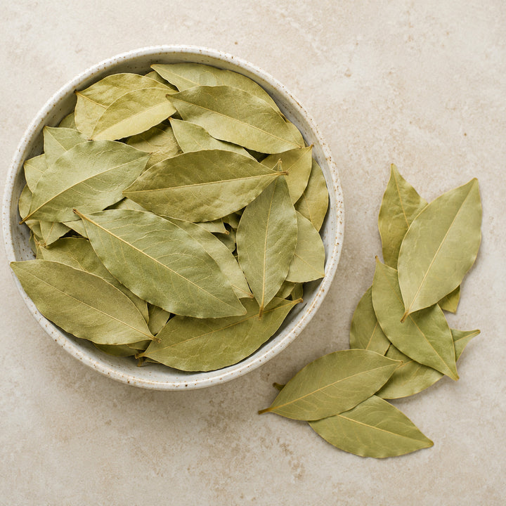 Whole dried bay leaves in a serving bowl