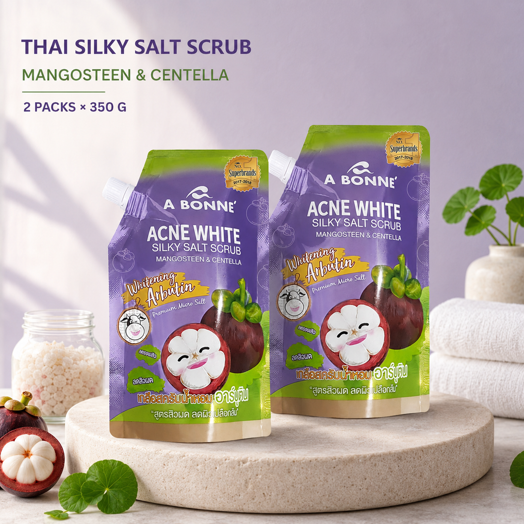 Two A BONNE Mangosteen and Centella Silky Salt Scrub pouches in a Thai spa setting