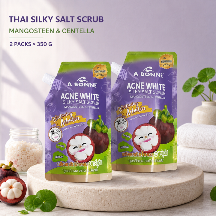 Two A BONNE Mangosteen and Centella Silky Salt Scrub pouches in a Thai spa setting