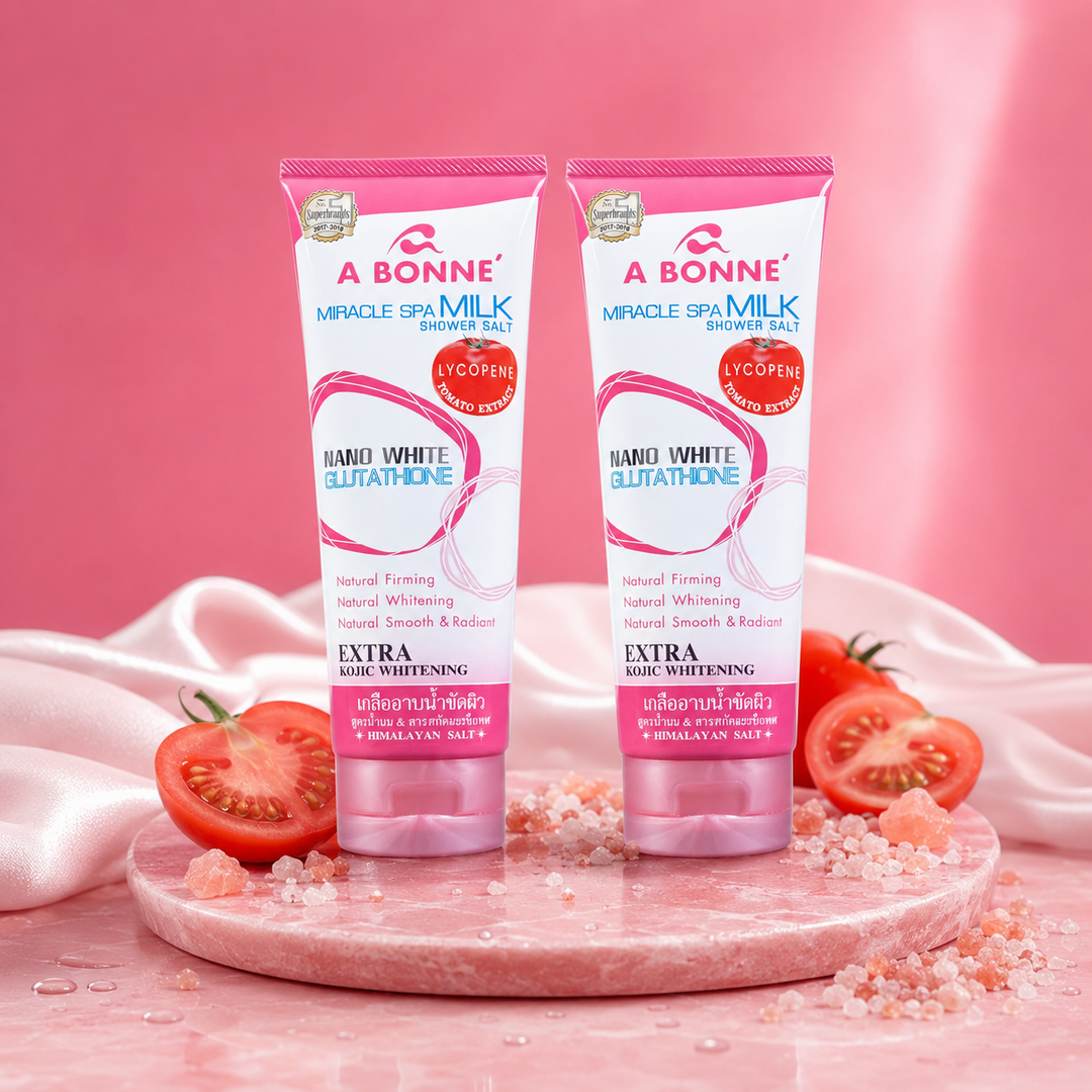 Two A BONNE Miracle Spa Milk Shower Salt tubes in a pink spa setting