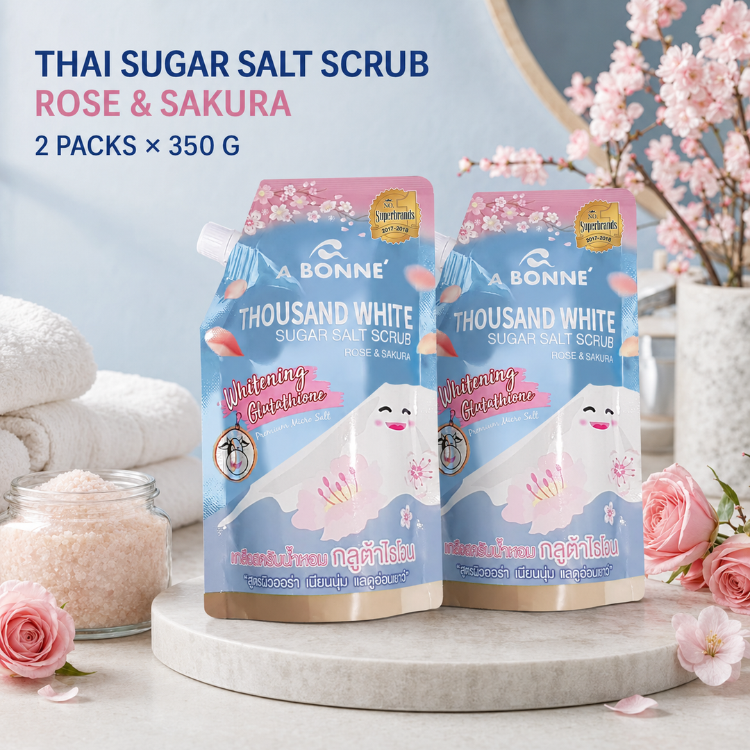 Two A BONNE Rose and Sakura Sugar Salt Scrub pouches in a floral spa setting