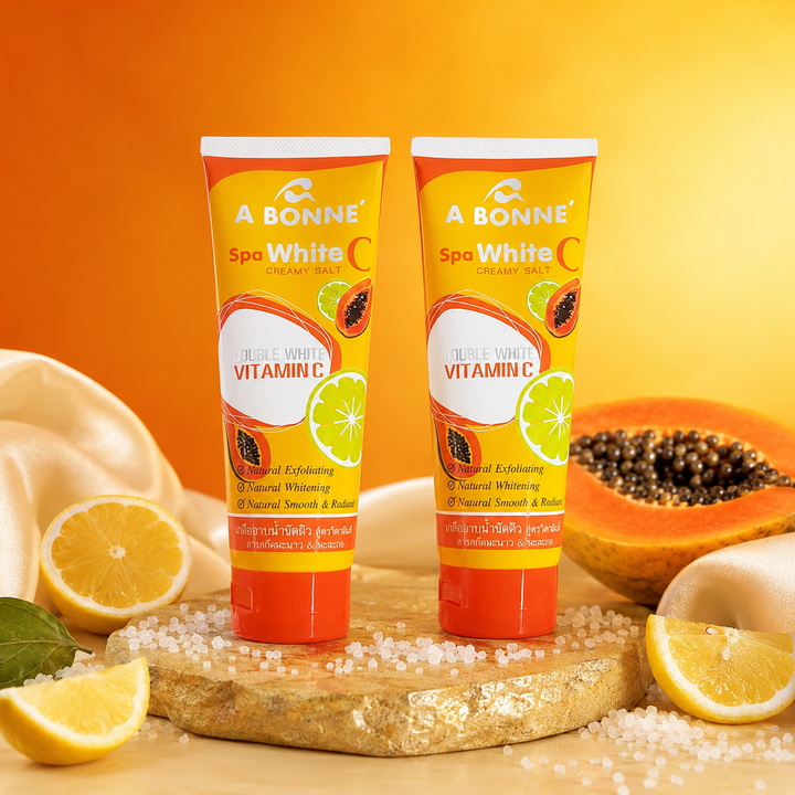 Two A BONNE Spa White C Creamy Salt tubes in a citrus spa setting