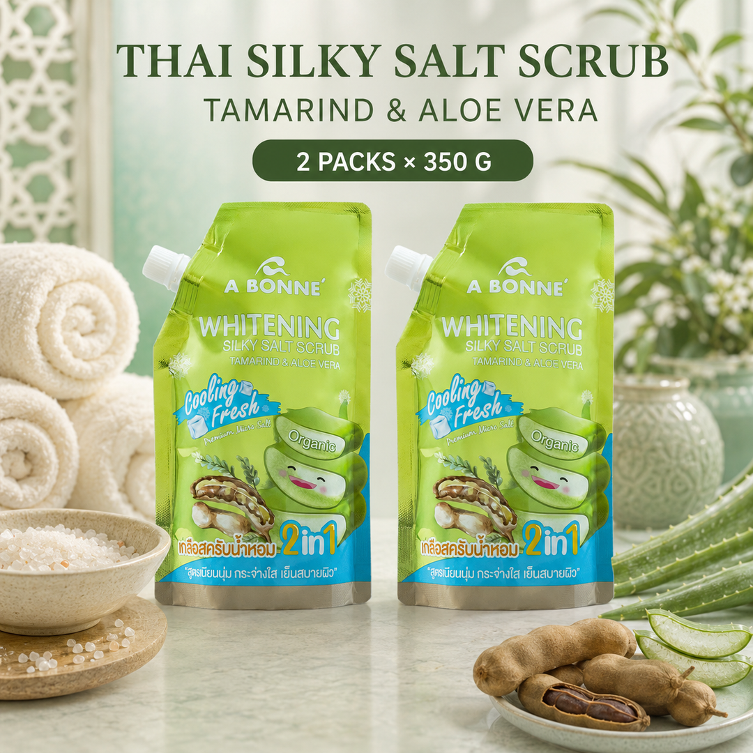 Two A BONNE Tamarind and Aloe Vera Cooling Silky Salt Scrub pouches in a Thai-inspired spa setting
