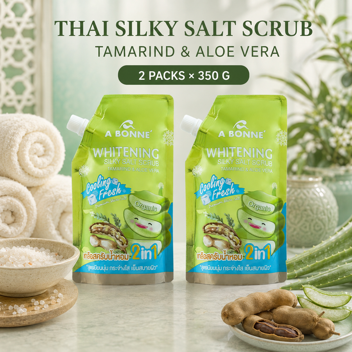 Two A BONNE Tamarind and Aloe Vera Cooling Silky Salt Scrub pouches in a Thai-inspired spa setting