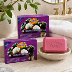 Two boxed bars and one unwrapped pink ASANTEE Mangosteen Soap bar in a bright bathroom