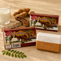 ASANTEE Tamarind and Goat Milk Soap with tamarind pods and milk in a warm spa setting