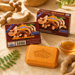Two boxes and one bar of ASANTEE Tamarind and Honey Soap with tamarind pods and honey