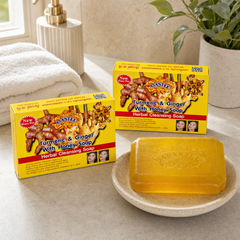 Two boxed bars and one unwrapped ASANTEE Turmeric Ginger With Honey Soap bar in a bright bathroom