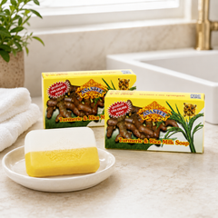 Two boxed bars and one unwrapped ASANTEE Turmeric and Rice Milk Soap bar in a bright bathroom