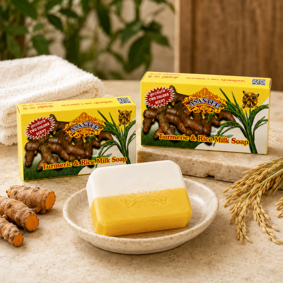 ASANTEE Turmeric and Rice Milk Soap three-bar bundle displayed with turmeric roots and rice stalks