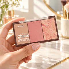 beWiLD Cheek Story, shade 01 Rosy, held in a hand at a beauty vanity