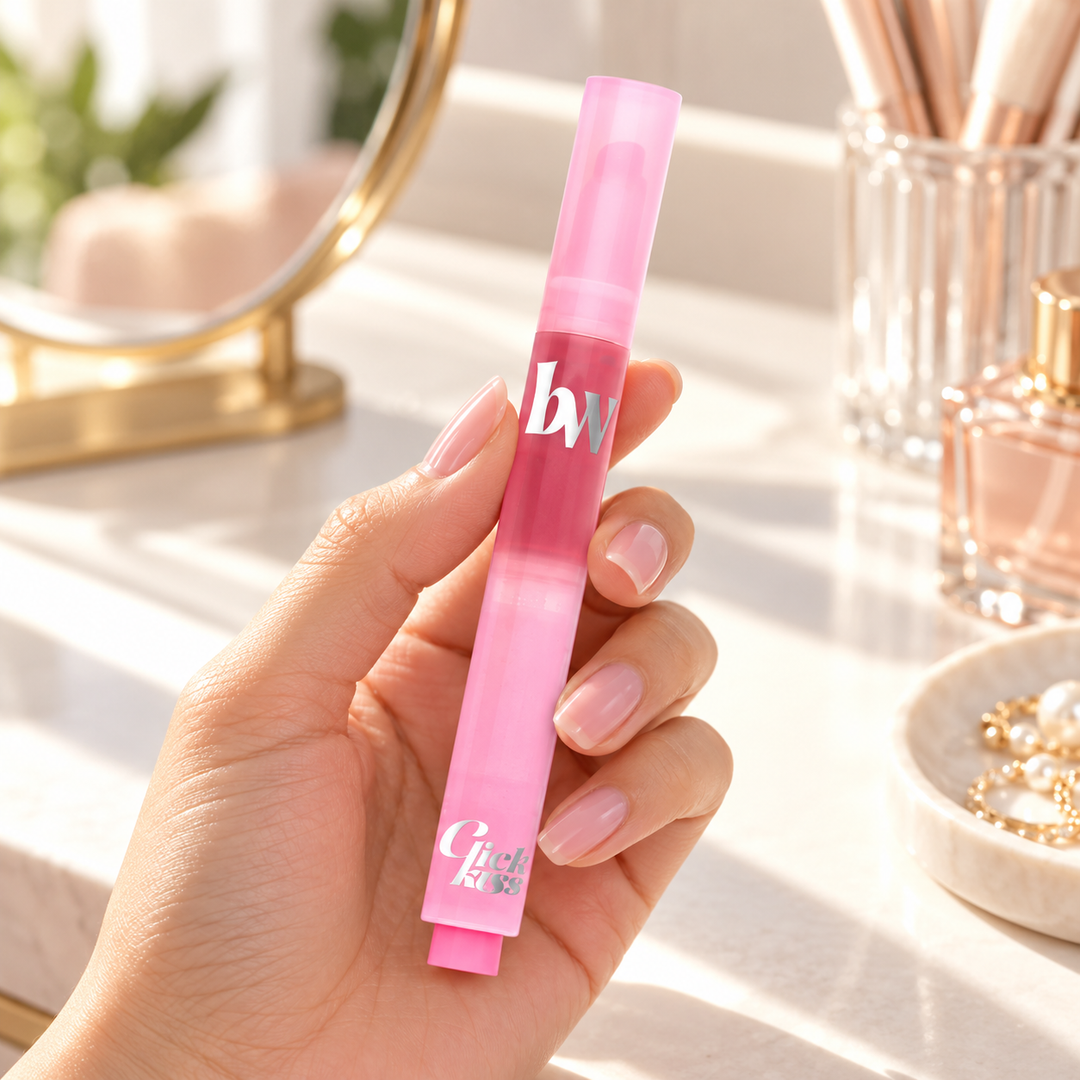 beWiLD Click Kiss Melting Lip, shade 01 Lily Lush, held in a hand at a beauty vanity