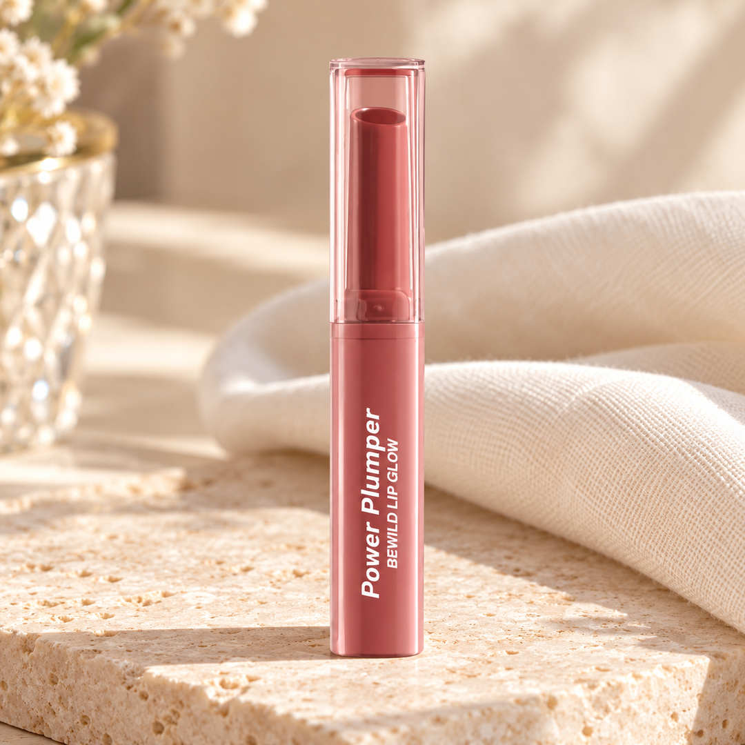 beWiLD Power Plumper Lip Glow, shade 01 Rose Tea, on a sunlit beauty vanity