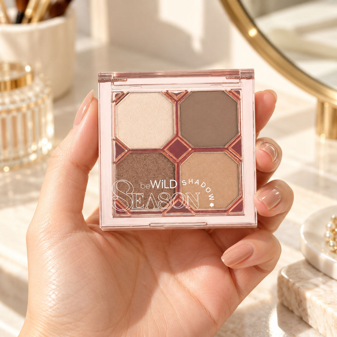 beWiLD Season Shadow, shade 01 Warm Autumn, held in a hand at a beauty vanity