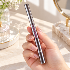 beWiLD Ultimate Brow, shade 01 Midnight Brown, held in a hand at a beauty vanity
