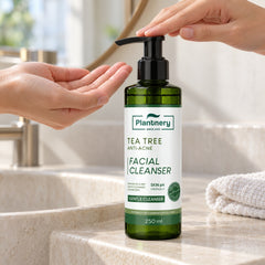 Using the pump of Plantnery Tea Tree Facial Cleanser 250 ml beside a washbasin