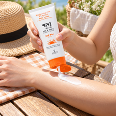 Scentio Milk Plus Q10 UV Protect Body Lotion SPF 50+ PA+++ 100 ml — body sunscreen being applied to an arm outdoors