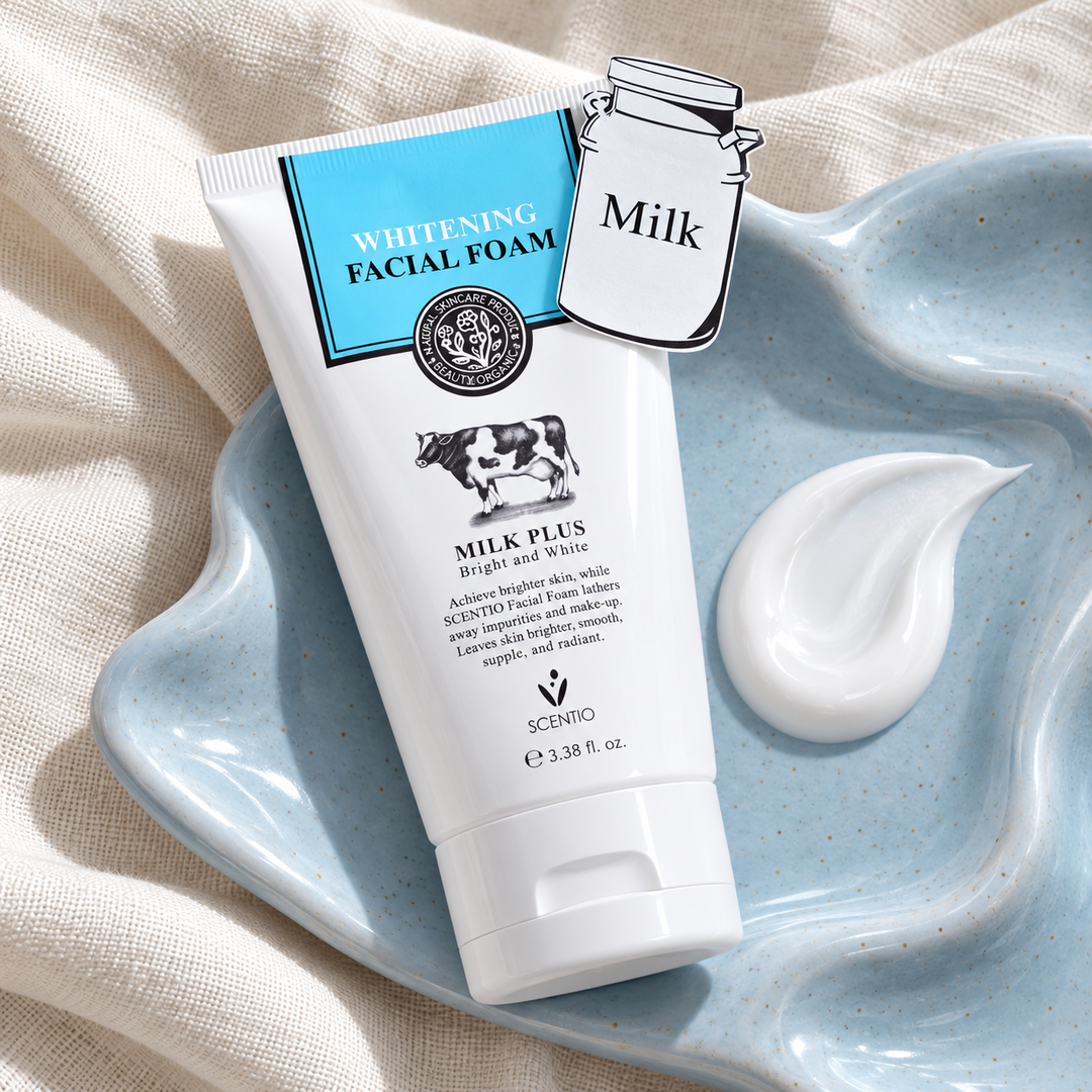Scentio Milk Plus Whitening Q10 Facial Foam 100 ml — tube beside towels and cleanser texture