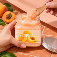 Scentio Apricot Anti-Aging Sherbet Scrub 350 ml — open apricot scrub jar held with a wooden spatula