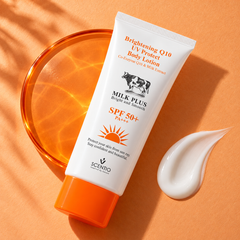 Scentio Milk Plus Q10 UV Protect Body Lotion SPF 50+ PA+++ 100 ml — tube beside lotion texture on an orange surface