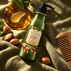Scentio Hair Professional Argan Oil Therapy Shampoo 500 ml — bottle beside argan nuts and hair-care accessories