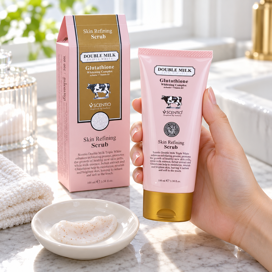 Scentio Double Milk Triple White Skin Refining Scrub 100 ml — scrub tube held beside its carton in a bathroom