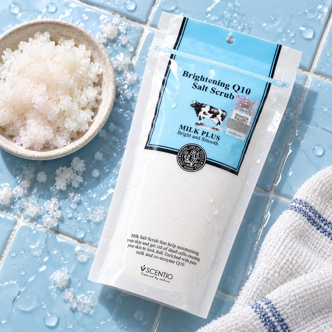 Scentio Milk Plus Brightening Q10 Salt Scrub 300 g — tube beside salt crystals and a towel