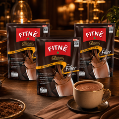 FITNÉ Choco Fiber three-pack bundle with a cup of cocoa in a warm café setting