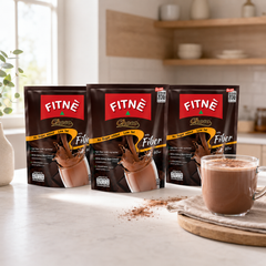 Three packs of FITNÉ Choco Fiber cocoa mix with a prepared cup of cocoa