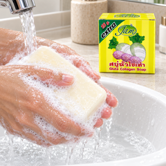 Hands lathering JAM Radish Gluta Collagen Soap under running water