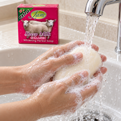 Hands lathering JAM Sheep Milk Collagen Soap under running water
