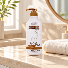 Made in Nature Goat Milk UV Body Lotion 450 ml on a stone bathroom vanity beside a folded ivory towel