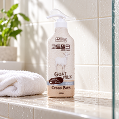 Made in Nature Goat Milk Cream Bath 450 ml on a tiled shower shelf beside a white washcloth