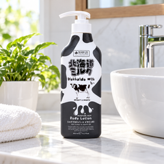 Made in Nature Hokkaido Milk Moisture Rich Body Lotion 450 ml beside a white bathroom sink and green plant