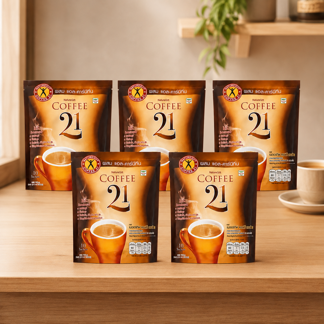 Five NatureGift Coffee 21 ten-sachet packs in a warm café setting