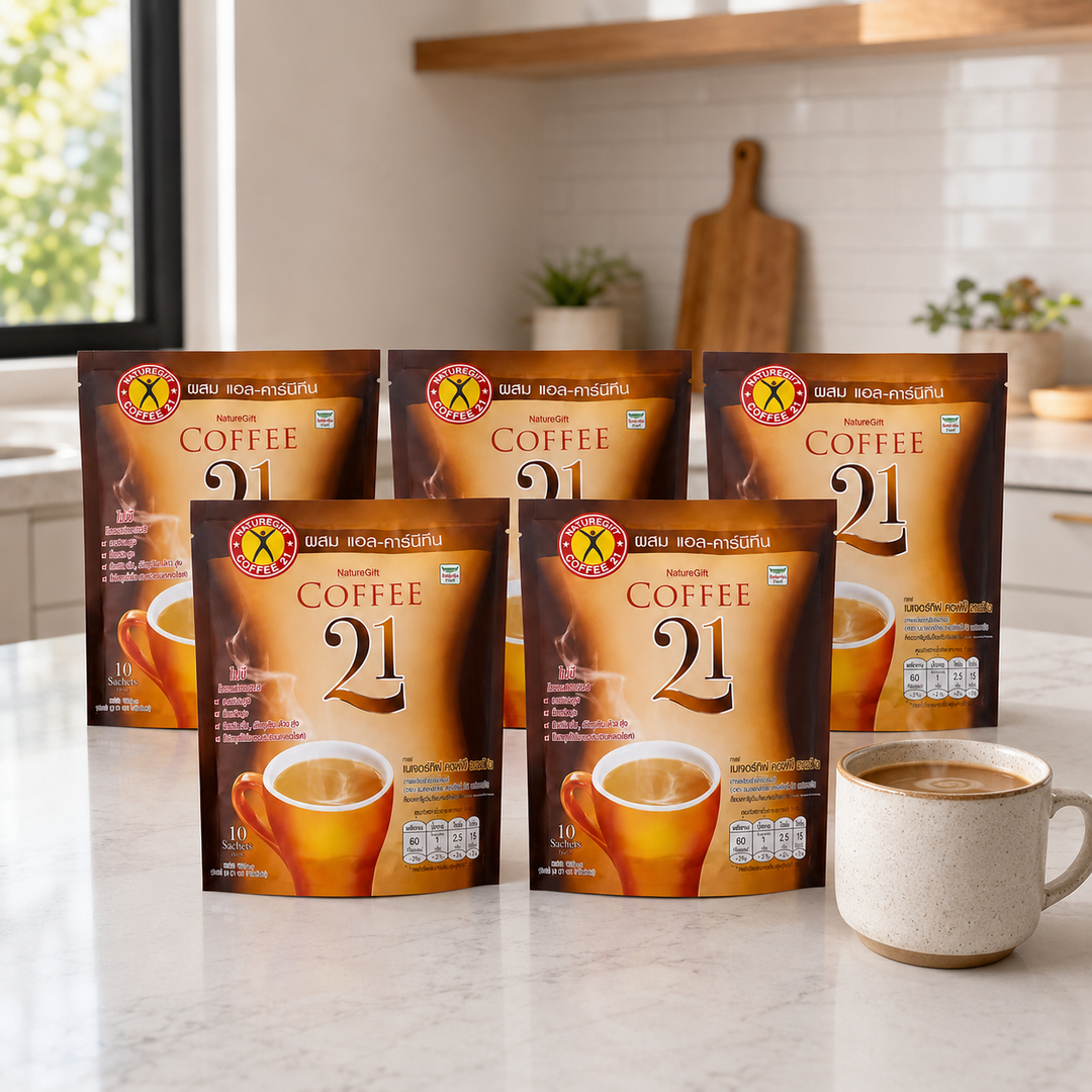 Five NatureGift Coffee 21 ten-sachet packs with a prepared coffee in a bright kitchen
