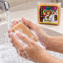 Niriko Tamarind Goat Milk Collagen soap lathered under running water