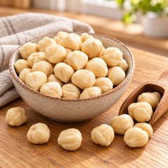 Shelled hazelnut kernels in a kitchen bowl — preparation suggestion