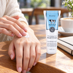Scentio Milk Plus Whitening Q10 Hand Cream 30 ml beside cream being applied to a hand