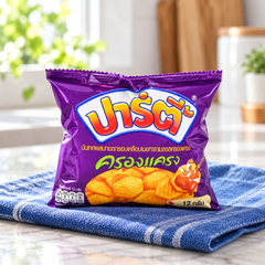 Party Krong Krang Crispy Sweet Potato Snacks, individual 12 g pouch in a lifestyle scene