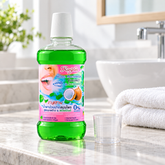Rasyan Coconut & Spearmint Mouthwash 500 ml beside a rinsing cup in a bathroom