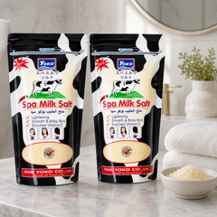 Two YOKO Spa Milk Salt 300 g pouches in a bright bathroom setting